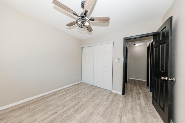 W169N11492 Biscayne Dr, Germantown, WI 53022 - unfurnished bedroom with light wood-style floors, a closet, and a ceiling fan