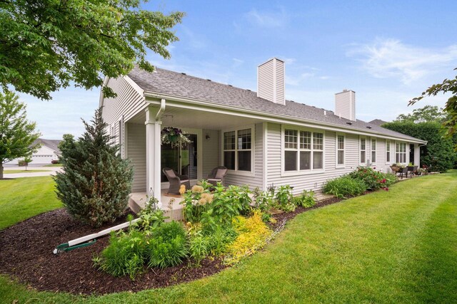 N52W35297 Lighthouse Ln, Oconomowoc, WI 53066 - rear view of property with a lawn, a patio, and a chimney