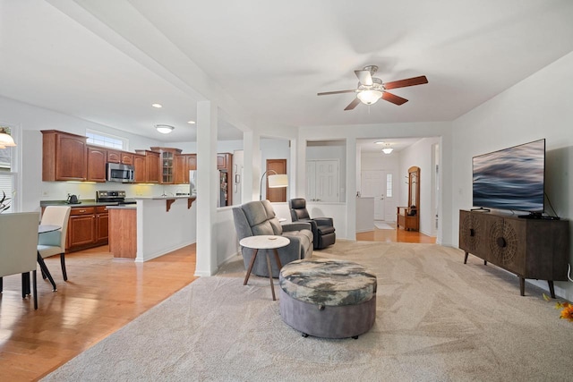 N52W35297 Lighthouse Ln, Oconomowoc, WI 53066 - living room featuring ceiling fan and light wood-style floors