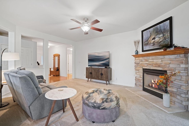N52W35297 Lighthouse Ln, Oconomowoc, WI 53066 - carpeted living room featuring ceiling fan and a stone fireplace