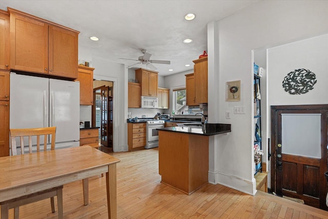 4069 N Prospect Ave, Shorewood, WI 53211 - kitchen with white appliances, a ceiling fan, dark countertops, a peninsula, and recessed lighting