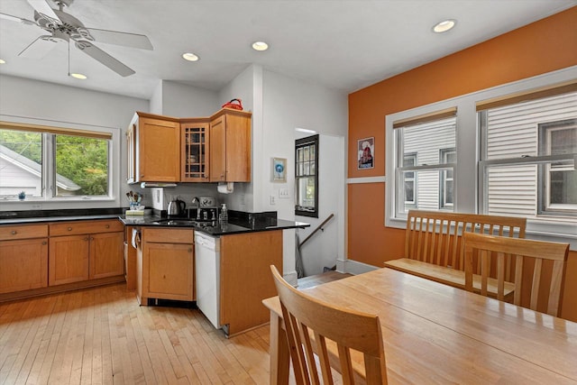 4069 N Prospect Ave, Shorewood, WI 53211 - kitchen featuring dishwasher, dark countertops, ceiling fan, glass insert cabinets, and light wood-style floors