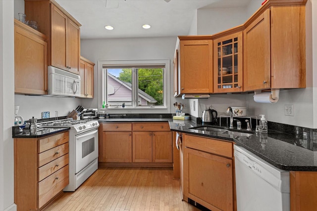 4069 N Prospect Ave, Shorewood, WI 53211 - kitchen featuring white appliances, glass insert cabinets, light wood finished floors, recessed lighting, and dark stone countertops