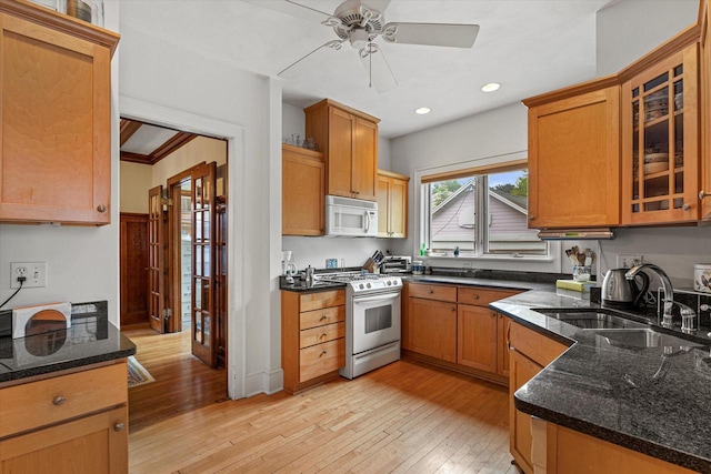 4069 N Prospect Ave, Shorewood, WI 53211 - kitchen featuring white microwave, gas stove, a ceiling fan, light wood-style floors, and dark stone counters