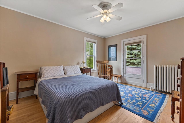 4069 N Prospect Ave, Shorewood, WI 53211 - bedroom with radiator, light wood-type flooring, access to exterior, crown molding, and a ceiling fan