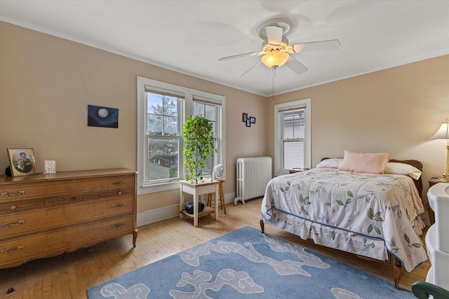 4069 N Prospect Ave, Shorewood, WI 53211 - bedroom featuring radiator heating unit, ornamental molding, light wood finished floors, and a ceiling fan