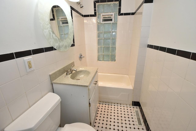 1600 Winslow St, Racine, WI 53404 - full bathroom featuring tile walls, vanity, and tile patterned flooring