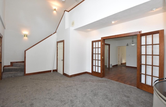 1600 Winslow St, Racine, WI 53404 - unfurnished living room featuring french doors, carpet, stairway, and high vaulted ceiling