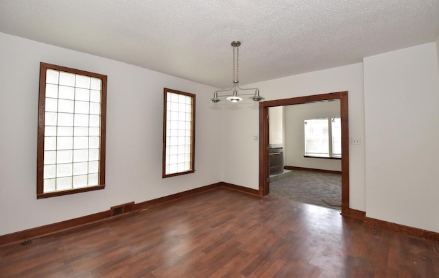 1600 Winslow St, Racine, WI 53404 - spare room with dark wood finished floors, a chandelier, and a textured ceiling
