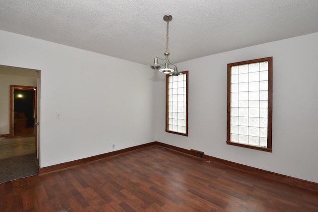 1600 Winslow St, Racine, WI 53404 - unfurnished room with dark wood-type flooring and a chandelier