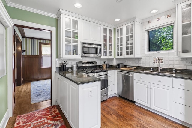 1853 N 83rd St, Wauwatosa, WI 53213 - kitchen featuring stainless steel appliances, white cabinetry, dark wood-style floors, crown molding, and glass insert cabinets