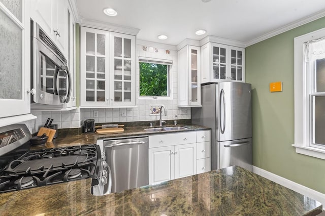 1853 N 83rd St, Wauwatosa, WI 53213 - kitchen featuring appliances with stainless steel finishes, backsplash, white cabinets, crown molding, and recessed lighting