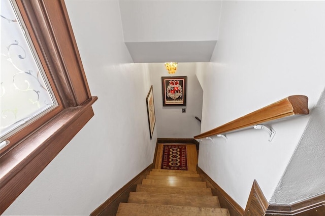 1853 N 83rd St, Wauwatosa, WI 53213 - staircase with a chandelier and baseboards