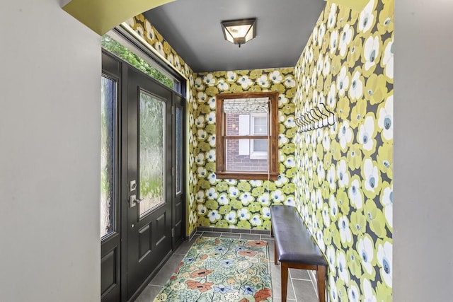 1853 N 83rd St, Wauwatosa, WI 53213 - entryway featuring plenty of natural light, dark tile patterned flooring, and wallpapered walls