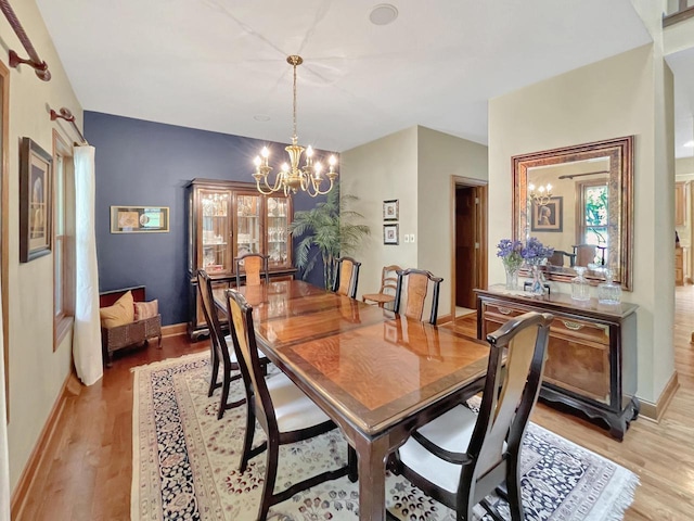 2307 W Willow Creek Ln, Sheboygan, WI 53083 - dining area with a chandelier and light wood-style floors