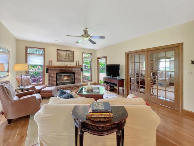 2307 W Willow Creek Ln, Sheboygan, WI 53083 - living area featuring wood finished floors, ceiling fan, a fireplace, and french doors