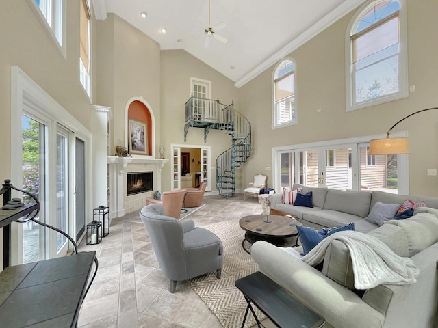 2307 W Willow Creek Ln, Sheboygan, WI 53083 - living area with high vaulted ceiling, stairway, a fireplace, ornamental molding, and a ceiling fan