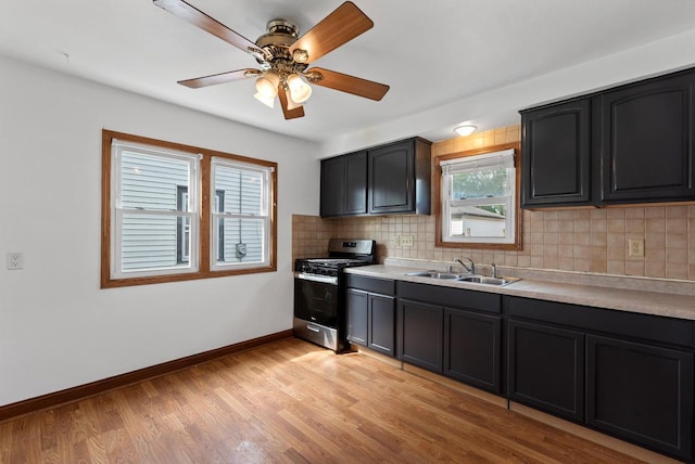 4467 S Nicholson Ave, Saint Francis, WI 53235 - kitchen featuring gas stove, backsplash, light countertops, ceiling fan, and light wood finished floors