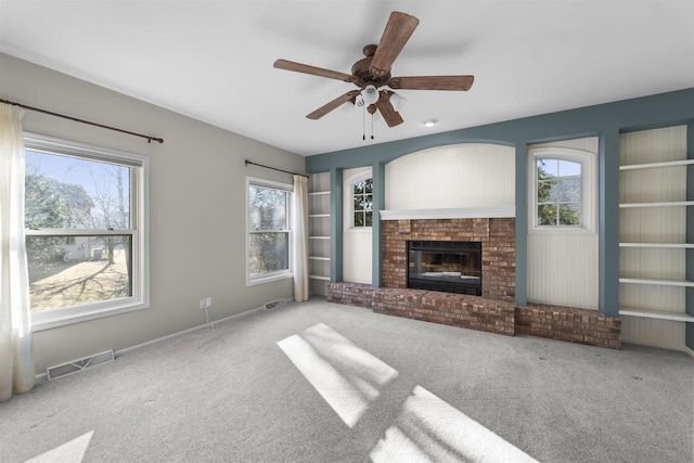 4227 Savannah Ct, Middleton, WI 53562 - unfurnished living room with carpet flooring, healthy amount of natural light, ceiling fan, and a fireplace