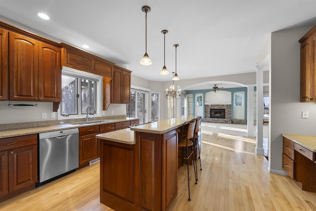 4227 Savannah Ct, Middleton, WI 53562 - kitchen with stainless steel dishwasher, a fireplace, a center island, a kitchen bar, and open floor plan