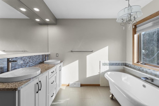 4227 Savannah Ct, Middleton, WI 53562 - bathroom featuring a freestanding bath, recessed lighting, double vanity, and a chandelier