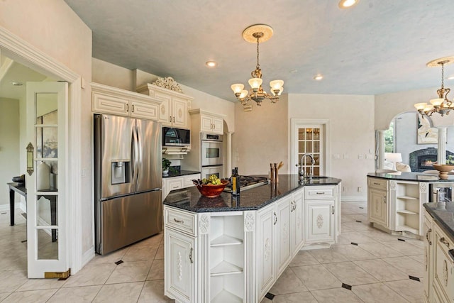 1626 Fox Hollow Ln, Cedarburg, WI 53012 - kitchen with appliances with stainless steel finishes, open shelves, a chandelier, cream cabinetry, and a kitchen island with sink