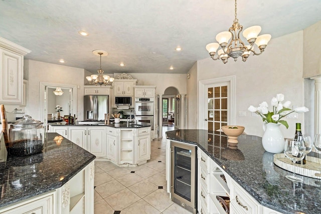 1626 Fox Hollow Ln, Cedarburg, WI 53012 - kitchen featuring wine cooler, a chandelier, stainless steel appliances, arched walkways, and open shelves