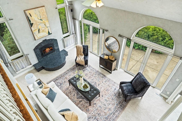 1626 Fox Hollow Ln, Cedarburg, WI 53012 - living area featuring carpet flooring, a lit fireplace, ceiling fan, and a high ceiling