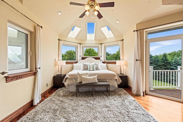 1626 Fox Hollow Ln, Cedarburg, WI 53012 - bedroom featuring access to outside, multiple windows, wood finished floors, lofted ceiling, and a skylight