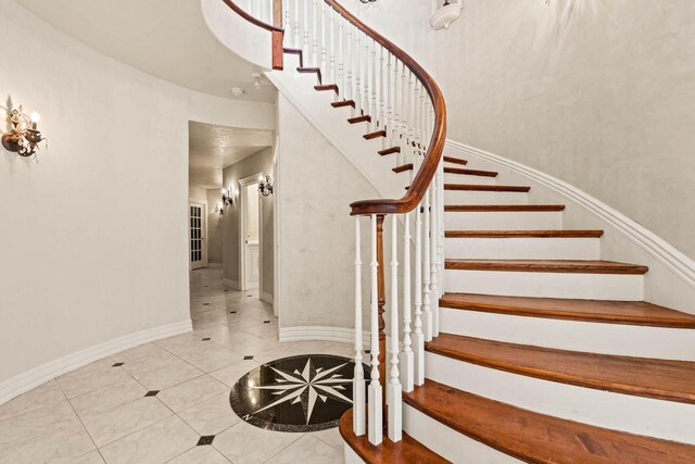 1626 Fox Hollow Ln, Cedarburg, WI 53012 - stairway with tile patterned flooring and inlaid floor details