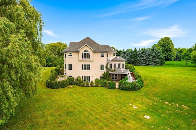 1626 Fox Hollow Ln, Cedarburg, WI 53012 - back of property with stucco siding, a lawn, a deck, and stairs