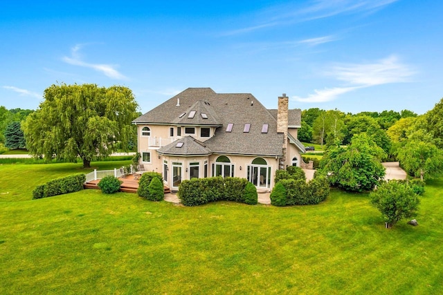 1626 Fox Hollow Ln, Cedarburg, WI 53012 - rear view of property with a deck, stucco siding, a chimney, a lawn, and a shingled roof