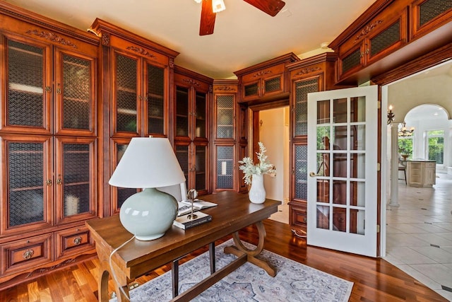1626 Fox Hollow Ln, Cedarburg, WI 53012 - office featuring a ceiling fan, arched walkways, and wood finished floors