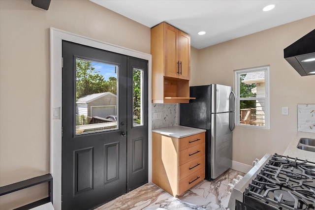 3009 N 72nd St, Milwaukee, WI 53210 - kitchen featuring light marble finish floors, plenty of natural light, stainless steel appliances, light countertops, and recessed lighting