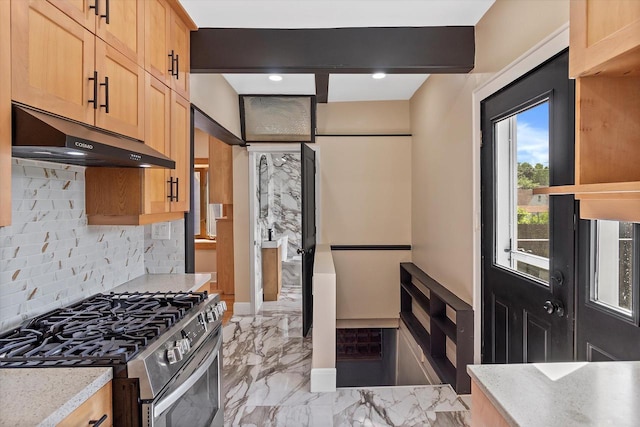 3009 N 72nd St, Milwaukee, WI 53210 - kitchen featuring stainless steel gas range, under cabinet range hood, decorative backsplash, light countertops, and light marble finish flooring