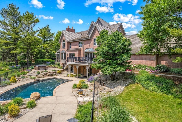 N69W29753 Ridgeview Ct, Hartland, WI 53029 - rear view of property featuring a wooden deck, brick siding, stairway, a chimney, and a patio area