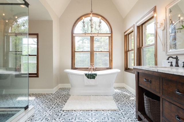 N69W29753 Ridgeview Ct, Hartland, WI 53029 - full bathroom with vanity, lofted ceiling, a stall shower, plenty of natural light, and a freestanding bath