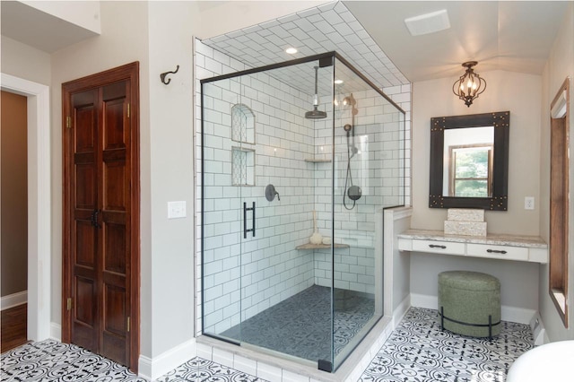 N69W29753 Ridgeview Ct, Hartland, WI 53029 - bathroom featuring a stall shower, tile patterned flooring, and a chandelier