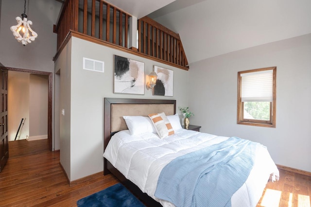 N69W29753 Ridgeview Ct, Hartland, WI 53029 - bedroom with wood finished floors, high vaulted ceiling, and a chandelier