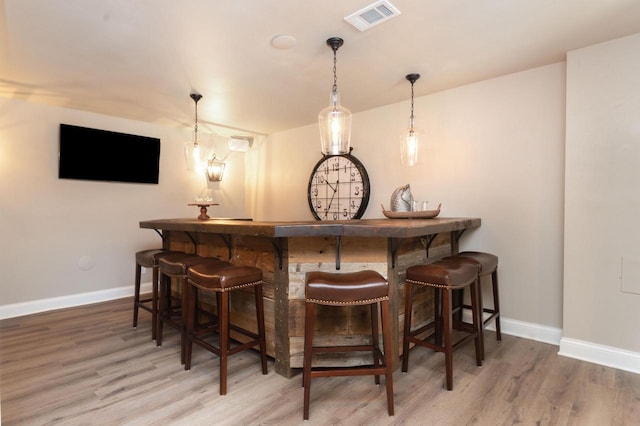 N69W29753 Ridgeview Ct, Hartland, WI 53029 - indoor dry bar with wood finished floors and hanging light fixtures