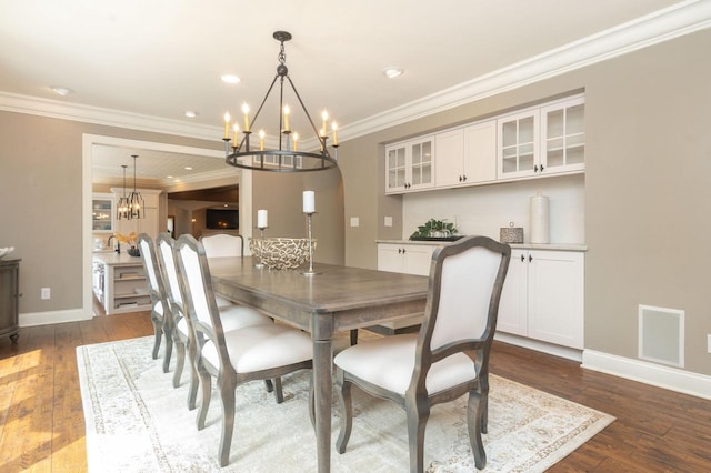 N69W29753 Ridgeview Ct, Hartland, WI 53029 - dining space featuring a chandelier, ornamental molding, dark wood-type flooring, and recessed lighting