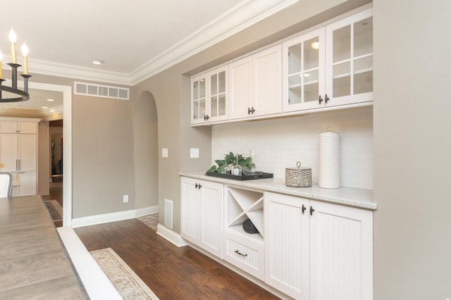 N69W29753 Ridgeview Ct, Hartland, WI 53029 - bar featuring arched walkways, ornamental molding, decorative backsplash, dark wood-style floors, and recessed lighting