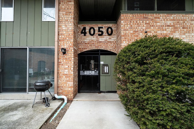 4050 W Rivers Edge Cir Unit 25, Brown Deer, WI 53209 - property entrance featuring brick siding and board and batten siding