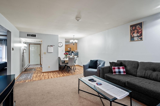 4050 W Rivers Edge Cir Unit 25, Brown Deer, WI 53209 - living area featuring a chandelier, light wood-style floors, and a baseboard heating unit