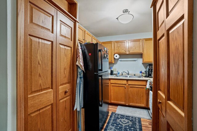 4050 W Rivers Edge Cir Unit 25, Brown Deer, WI 53209 - kitchen with freestanding refrigerator, light countertops, and light wood-type flooring