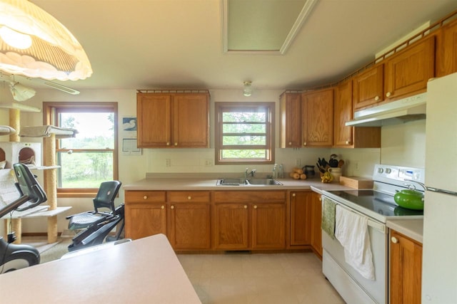 N5642 8th Dr, Westfield, WI 53964 - kitchen with white appliances, under cabinet range hood, light countertops, and brown cabinets