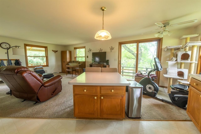 N5642 8th Dr, Westfield, WI 53964 - kitchen featuring open floor plan, light countertops, hanging light fixtures, and brown cabinets
