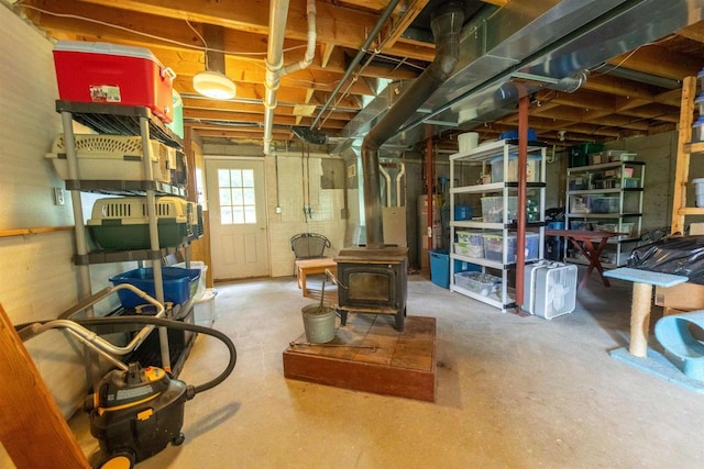 N5642 8th Dr, Westfield, WI 53964 - below grade area featuring a wood stove, water heater, and heating unit