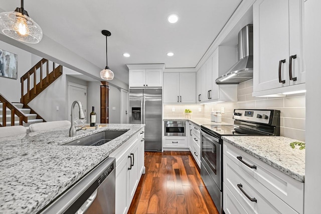 836 Pilgrim Pkwy, Elm Grove, WI 53122 - kitchen with stainless steel appliances, wall chimney exhaust hood, recessed lighting, dark wood-style floors, and white cabinetry