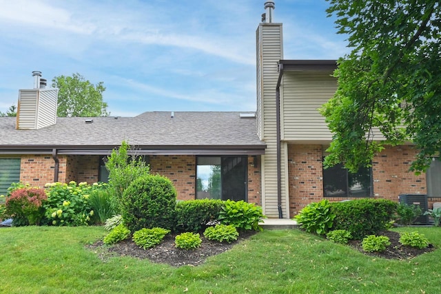 836 Pilgrim Pkwy, Elm Grove, WI 53122 - back of property featuring a chimney, brick siding, and a yard